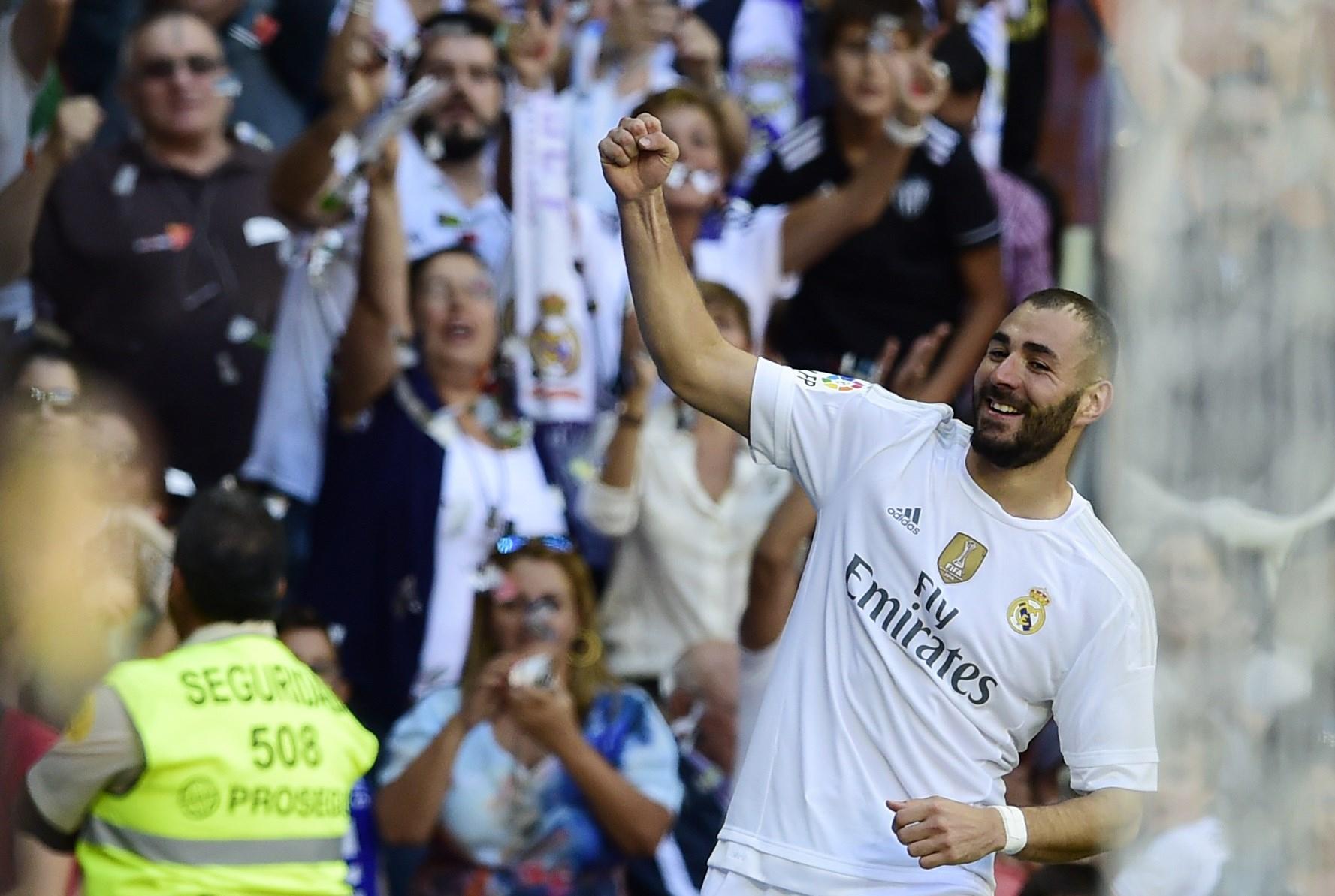 Real Madrid's French forward Karim Benzema celebrates after scoring a goal during the Spanish league football match Real Madrid CF vs Granada FC at the Santiago Bernabeu stadium in Madrid on Spetember 19, 2015. AFP PHOTO/ JAVIER SORIANO (Photo credit should read JAVIER SORIANO/AFP/Getty Images)