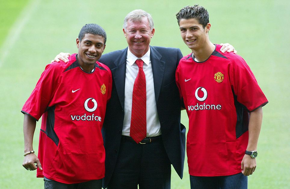 THIS PICTURE CAN ONLY BE USED WITHIN THE CONTEXT OF AN EDITORIAL FEATURE. NO WEBSITE/INTERNET USE UNLESS SITE IS REGISTERED WITH FOOTBALL ASSOCIATION PREMIER LEAGUE.Manchester United manager Sir Alex Ferguson with new signings Kleberson (L) and Christiano Ronaldo are unvieled at a press conference at Old Trafford, Wednesday 13th August, 2003.The addition of Ronaldo, Kleberson and Cameroon international Eric Djemba-Djemba means Ferguson has an extra option in midfield even after the departures of David Beckham and Juan Sebastian Veron. See PA story SOCCER ManUtd. PA Photo: Martin Rickett.