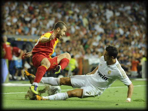 Real Madrid's Portuguese forward Cristiano Ronaldo (R) vies with Galatasaray���s Kurtulus (L) during their Santiago Bernabeu trophy football match against at the Santiago Bernabeu Stadium, August 24, 2011 in Madrid. Real Madrid won 2-1. AFP PHOTO/Pedro ARMESTRE (Photo credit should read PEDRO ARMESTRE/AFP/Getty Images)