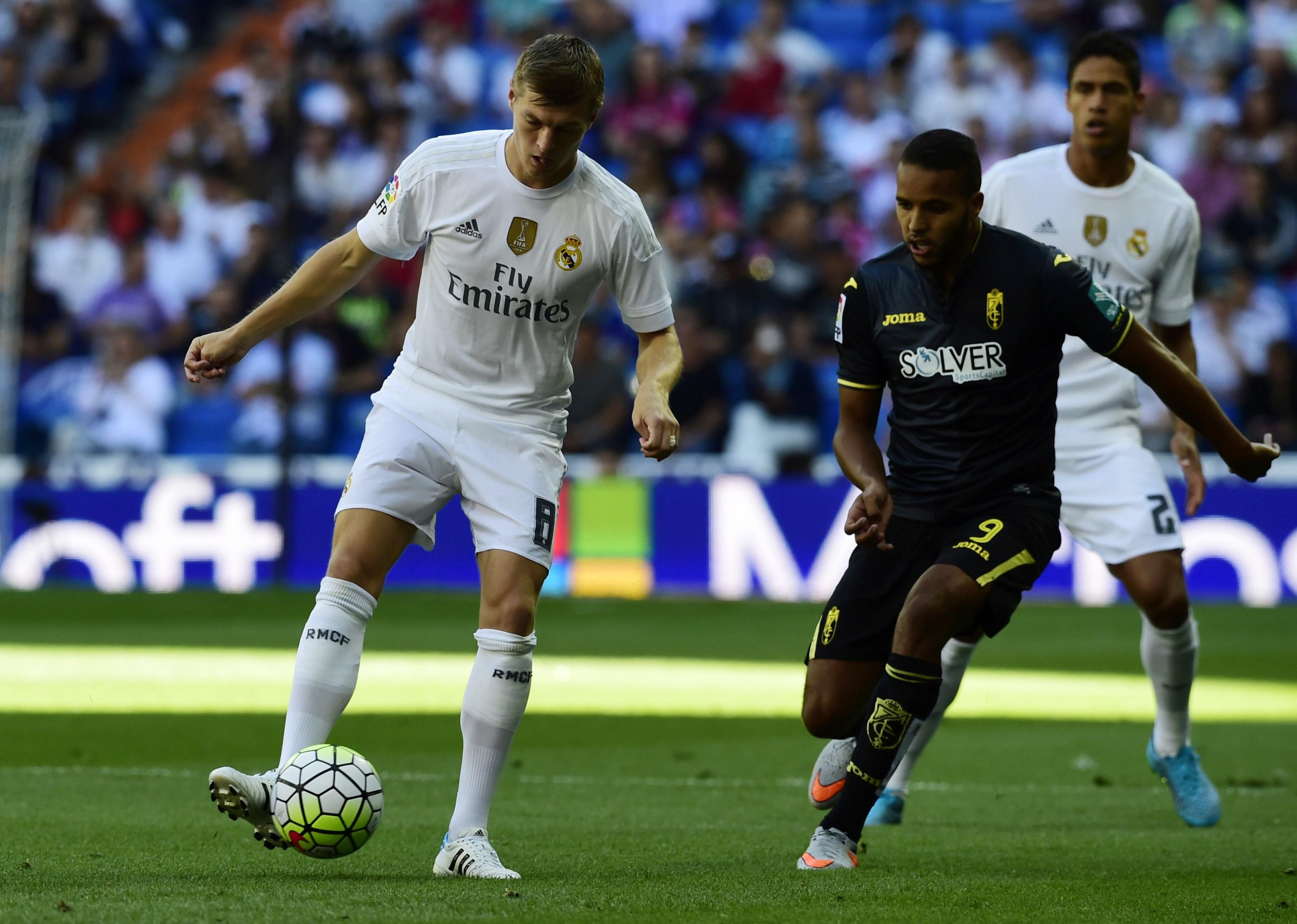 Real Madrid's German midfielder Toni Kroos (L) vies with Granada's Moroccan forward Youssef El-Arabi during the Spanish league football match Real Madrid CF vs Granada FC at the Santiago Bernabeu stadium in Madrid on Spetember 19, 2015. AFP PHOTO/ JAVIER SORIANO (Photo credit should read JAVIER SORIANO/AFP/Getty Images)