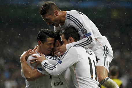 Real Madrid's Bale celebrates with teammates Bale and Ramos after scoring a goal against Borussia Dortmund during their Champions League quarter-final first leg soccer match at Santiago Bernabeu stadium in Madrid