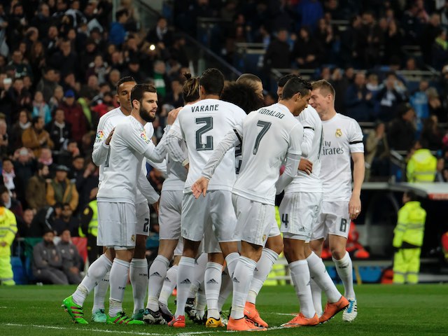 Real Madrid's soccer players celebrate scoring during the Spanish league football match Real Madrid CF vs Sevilla FC at the Santiago Bernabeu stadium in Madrid on March 20, 2016. / AFP / PEDRO ARMESTRE        (Photo credit should read PEDRO ARMESTRE/AFP/Getty Images)