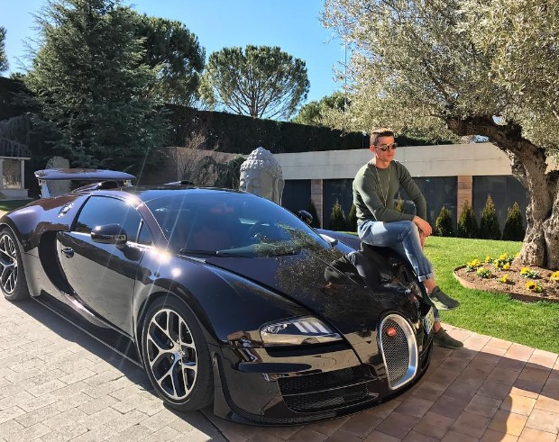 WOW!! Cristiano Ronaldo poses with his beast Bugatti Veyron as he is back on training ground