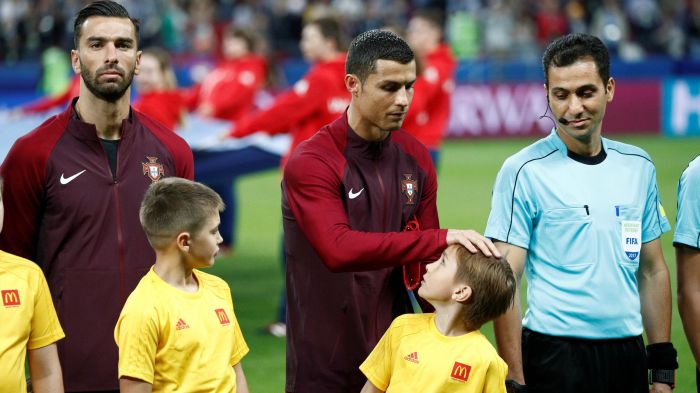 Cristiano Ronaldo signs Mascot's Shirt before Kick-Off for Confederations Cup Match vs Chile